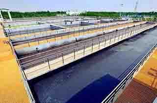 FRP plant access flooring with drainage covers and corrosion-resistant infrastructure supports at a water treatment facility.